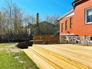 a wooden deck in front of a house at 5 person holiday home in Sibbhult-By Traum in Sibbhult