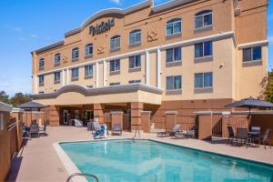 a hotel with a swimming pool in front of a building at Fairfield Inn & Suites Rancho Cordova in Rancho Cordova