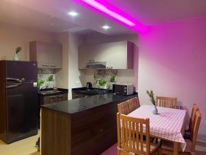 a kitchen with a table and a purple light at ازها العين السخنه in Ain Sokhna