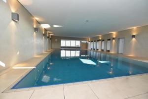 a large swimming pool in a large building at Haus "Atlantic" Appartement ATL 604B in Cuxhaven