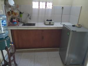a kitchen with a sink and a counter top at Purana Guest House in Tabanan