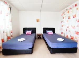 Postel nebo postele na pokoji v ubytování D' Limbai Cottage