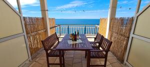 a table on a balcony with a view of the ocean at Apartments Ana i Ante Punta in Milna