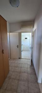 an empty room with a door and a tile floor at Apartments Ana i Ante Punta in Milna