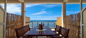 a table on a porch with a view of the ocean at Apartments Ana i Ante Punta in Milna