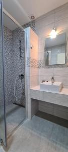 a bathroom with a sink and a shower at Apartments Ana i Ante Punta in Milna
