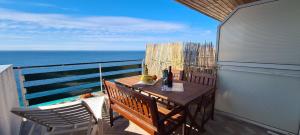 a balcony with a table and chairs and the ocean at Apartments Ana i Ante Punta in Milna