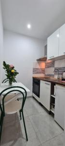 a kitchen with a table and a vase of flowers at Apartments Ana i Ante Punta in Milna