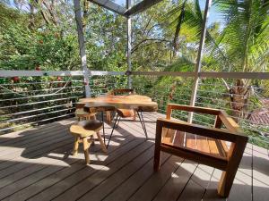a wooden deck with a table and chairs on it at Nangu lodge in Sámara