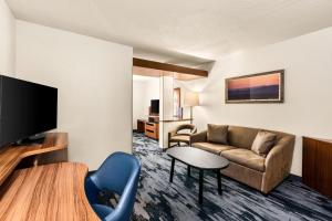 a living room with a couch and a tv at Fairfield Inn & Suites by Marriott San Antonio Downtown/Market Square in San Antonio