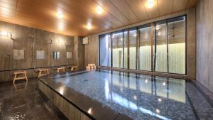 a swimming pool in a building with a large window at Gion Shinmonso in Kyoto