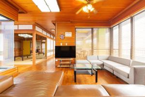 uma sala de estar com um sofá e uma televisão em Oriental Villa - Vacation STAY 09167v em Ishigaki