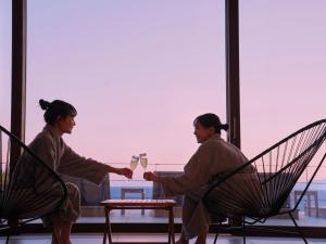 two women sitting at a table with glasses of wine at Oiso Prince Hotel in Oiso