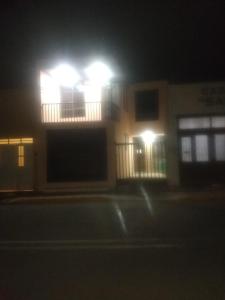 a building with lights on top of it at night at Ola in Aguascalientes