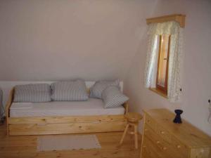 a bedroom with a bed with pillows and a window at Holiday home in Jilove u Drzkova 1767 in Jílové u Držkova
