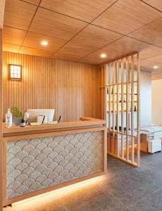 an office with a reception counter with a desk at Tomonoya Signature Ryokan Namhae in Namhae