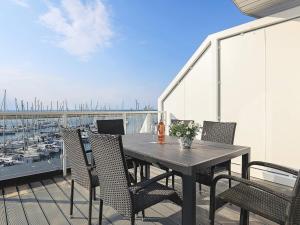 a table and chairs on a balcony with a marina at Apartment Wendtorf XXIV in Wendtorf