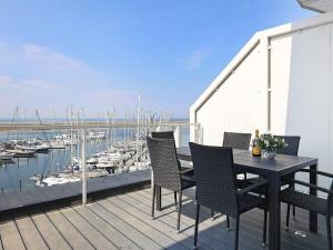 a table and chairs on a balcony with a marina at Apartment Wendtorf XXIX in Wendtorf
