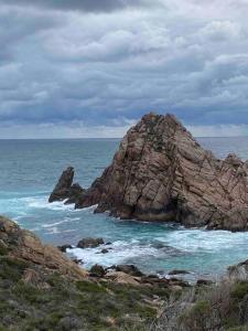 a large rock in the ocean next to the water at Panda's Patch Dunsborough in Dunsborough