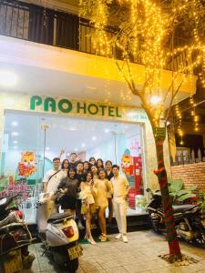 a group of people standing in front of a store at Pao Hotel in Hue