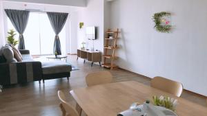a living room with a table and a couch at Traveler's homestay 旅人窝@ The Venus Sitiawan in Kampong Lumut Kiri