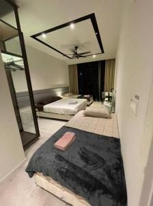 a bedroom with two beds and a mirror at ExpressionZ Suites KLCC by EC in Kuala Lumpur