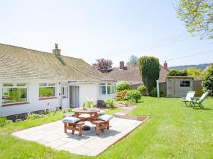 a house with a patio and a table in the yard at Blue Horizon in Sidmouth