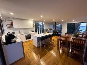 a kitchen and living room with a table and chairs at Jindabyne Lake View in Jindabyne