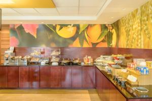 a buffet line in a restaurant with a mural at Fairfield Inn Saint Louis Collinsville in Collinsville