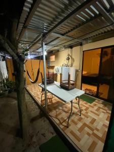 a living area with a table and a room at La Casa de Cachi in Paquera