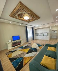 a large living room with a couch and a rug at Eagle Town Serviced Apartment- Free Pick up from Airport in Ulaanbaatar