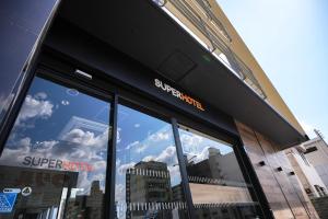 a store window with a reflection of the sky in it at Super Hotel Utsunomiya in Utsunomiya
