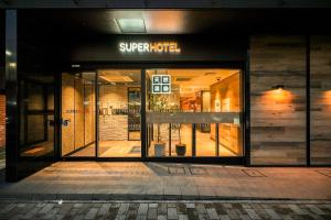 a store front with its doors open at night at Super Hotel Utsunomiya in Utsunomiya