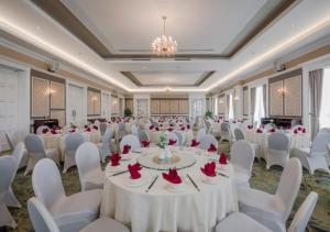 a banquet hall with white tables and white chairs at FLC Luxury Resort Vinh Phuc in Hoằng Xá
