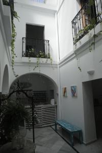 a courtyard with a bench in a building at Wake up in Tarifa Hostel & Restaurant Lounge in Tarifa