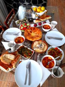 a table topped with plates and bowls of food at Guesthouse of Irina in Chvabiani