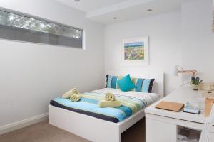 a bedroom with a bed with towels on it at Smithys Shore Thing in Smiths Beach