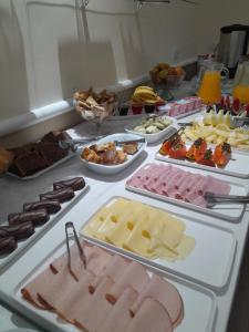 a buffet with many different types of meats and cheeses at Hotel Paris in Sao Paulo