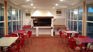 a restaurant with tables and chairs and a fireplace at Wara Kusi cottages, in Salta Argentina in Salta