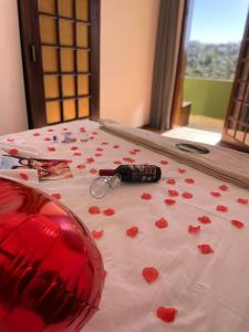 a table with red hearts and glasses on it at Pousada Casa de Campos Mountain House in Campos do Jordão