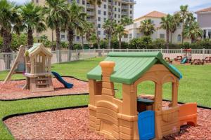 a playground with two play equipment in a park at New Stunning Ocean-View Condo in Beachfront Resort in South Padre Island