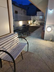 a bench sitting outside of a restaurant at night at Case Vacanza Armando "Lipari" in Canneto
