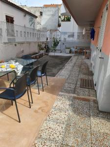 a patio with a table and chairs on a tile floor at Case Vacanza Armando "Lipari" in Canneto