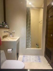 a bathroom with a toilet and a sink and a shower at Las Tortugas, Cozy condominium on Khao Tao beach, Hua Hin in Khao Tao