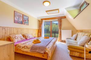 1 dormitorio con 1 cama y 1 sofá en Penzion Na Lomné en Trojanovice