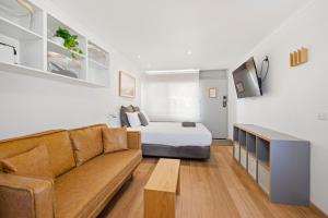 a living room with a bed and a couch at Moody's Motel in Blairgowrie