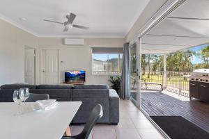 a living room with a couch and a table at The Leaning Oak Holiday Lifestyles - Lake Conjola in Conjola