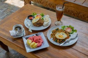 un tavolo con due piatti di cibo e una bevanda di Favorit Exclusive Villa & Bungalow a Nusa Penida