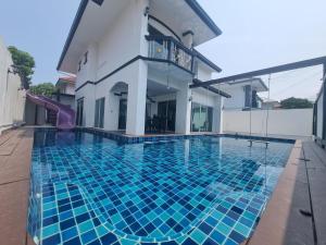a pool in the backyard of a house with a slide at Eldorado pool villa 6br in Jomtien Beach