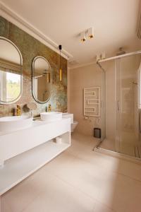 a bathroom with two sinks and a shower at Gold Wave Apartments in Siófok